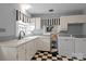 Laundry room with white cabinets, modern washer, dryer, and black and white tile flooring at 747 9Th Nw St, Hickory, NC 28601