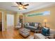 Bright living room with hardwood floors, ceiling fan, built-in shelving, and neutral toned furniture at 747 9Th Nw St, Hickory, NC 28601
