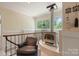 Cozy loft area with a unique fireplace, comfortable seating, and natural light from nearby windows at 747 9Th Nw St, Hickory, NC 28601