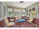 Sunroom featuring red brick floor and many windows with views of the yard at 747 9Th Nw St, Hickory, NC 28601