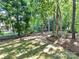 Spacious backyard with lush trees, grass, and a classic black fence at 9000 Whirlaway Ln, Waxhaw, NC 28173
