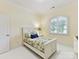 Cozy bedroom with a twin bed, arched window, and neutral decor, creating a serene atmosphere at 9000 Whirlaway Ln, Waxhaw, NC 28173
