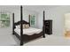 Bedroom with a four-poster bed, neutral carpet, and bright windows creating a comfortable retreat at 9000 Whirlaway Ln, Waxhaw, NC 28173