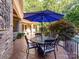 Relaxing covered patio with outdoor dining area and views of the lush backyard and pool at 9000 Whirlaway Ln, Waxhaw, NC 28173