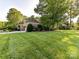 Beautiful home with manicured lawn and landscaping in a tranquil setting, showcasing impeccable curb appeal at 9000 Whirlaway Ln, Waxhaw, NC 28173