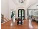 Grand foyer featuring hardwood floors, high ceilings, elegant lighting, and a striking front door at 9000 Whirlaway Ln, Waxhaw, NC 28173