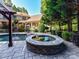 Inviting backyard featuring a spa, swimming pool, stone patio, and lush landscaping at 9000 Whirlaway Ln, Waxhaw, NC 28173