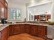 Kitchen with wood cabinets, stainless appliances, and granite countertops open to living room at 9000 Whirlaway Ln, Waxhaw, NC 28173