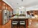 Kitchen with wood cabinets, stainless appliances, granite countertops and an island with seating at 9000 Whirlaway Ln, Waxhaw, NC 28173