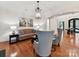 Elegant living room featuring hardwood floors, a decorative light fixture, and comfortable seating at 9000 Whirlaway Ln, Waxhaw, NC 28173