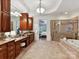 Main bathroom with tiled floor, granite countertops, a tub, and glass enclosed shower at 9000 Whirlaway Ln, Waxhaw, NC 28173