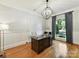 Well-lit home office with hardwood floors, wainscoting and a large window overlooking the yard at 9000 Whirlaway Ln, Waxhaw, NC 28173