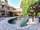 Gorgeous pool with stone surround, outdoor patio, and lush landscaping creates a backyard oasis at 9000 Whirlaway Ln, Waxhaw, NC 28173