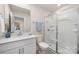 Bright bathroom featuring a vanity with quartz countertop, a walk-in shower and a neutral tile flooring at 9311 Dunwich Dr, Gastonia, NC 28056