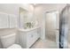 Bathroom featuring a double vanity sink with a modern mirror and bright lighting at 9311 Dunwich Dr, Gastonia, NC 28056