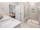 Modern bathroom with a glass-enclosed shower, sleek countertops, and neutral tile at 9311 Dunwich Dr, Gastonia, NC 28056