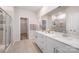 Elegant bathroom with a double vanity, quartz countertop, walk-in shower, and neutral tile flooring at 9311 Dunwich Dr, Gastonia, NC 28056