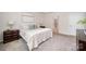 Bright bedroom featuring neutral decor, plush carpet, and an ensuite bathroom at 9311 Dunwich Dr, Gastonia, NC 28056