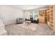 Cozy bonus room with comfortable seating, built-in shelving, and natural light, perfect for relaxation at 9311 Dunwich Dr, Gastonia, NC 28056