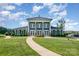 Exterior of community clubhouse with elegant architectural details and beautifully landscaped grounds at 9311 Dunwich Dr, Gastonia, NC 28056