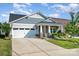 Charming home featuring stone accents, a two-car garage, and a well-manicured lawn at 9311 Dunwich Dr, Gastonia, NC 28056