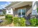 Charming front porch with stone accents, a cozy bench, and lush landscaping at 9311 Dunwich Dr, Gastonia, NC 28056
