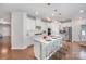 Modern kitchen featuring a central island with bar seating and elegant pendant lights at 9311 Dunwich Dr, Gastonia, NC 28056