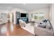 Comfortable living room with plenty of natural light, stylish furniture, and hardwood floors at 9311 Dunwich Dr, Gastonia, NC 28056