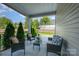 Inviting covered patio with comfortable seating and a view of the landscaped backyard at 9311 Dunwich Dr, Gastonia, NC 28056