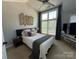 Bright bedroom with large window and modern ceiling fan at 1013 Park West Dr # 5, Charlotte, NC 28209