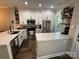 Modern kitchen with white cabinetry, stainless steel appliances, and an island with a quartz countertop at 1013 Park West Dr # 5, Charlotte, NC 28209