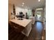 Modern kitchen with white cabinets, stainless appliances, breakfast bar, and hardwood floors at 1013 Park West Dr # 5, Charlotte, NC 28209