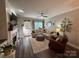 Bright living room with fireplace, comfortable seating, ceiling fan and hardwood floors at 1013 Park West Dr # 5, Charlotte, NC 28209