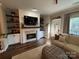Cozy living room with a brick fireplace, built-in shelving, and comfortable seating at 1013 Park West Dr # 5, Charlotte, NC 28209