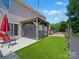 The backyard features a gazebo, lush green lawn and a patio at 10409 Dominion Village Dr, Charlotte, NC 28269