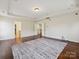 Bright bedroom with hard wood floors, recessed lighting, and doorway to the bathroom and closet at 10409 Dominion Village Dr, Charlotte, NC 28269