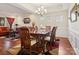 Elegant dining room with wood table, chandelier, and views into a living area, perfect for entertaining at 10409 Dominion Village Dr, Charlotte, NC 28269