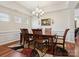 Elegant dining room featuring a wooden table, upholstered chairs, and decorative accents at 10409 Dominion Village Dr, Charlotte, NC 28269