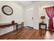 Elegant foyer featuring hardwood floors, a decorative mirror, and stylish accent furniture at 10409 Dominion Village Dr, Charlotte, NC 28269