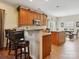 Well-lit kitchen with breakfast bar, island, modern appliances, and an adjacent dining area, perfect for casual meals at 10409 Dominion Village Dr, Charlotte, NC 28269