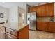 Spacious kitchen with stainless steel refrigerator, granite countertops, and ample cabinet space at 10409 Dominion Village Dr, Charlotte, NC 28269