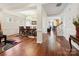 Open-concept living room and dining area with hardwood floors and abundant natural light at 10409 Dominion Village Dr, Charlotte, NC 28269