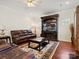 Spacious living room with a large entertainment center, plush leather seating, and a ceiling fan at 10409 Dominion Village Dr, Charlotte, NC 28269