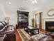 Cozy living room with fireplace, large entertainment center, and comfortable seating; perfect for relaxation at 10409 Dominion Village Dr, Charlotte, NC 28269