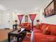 Inviting living room with hardwood floors, cozy sofas, and ample natural light at 10409 Dominion Village Dr, Charlotte, NC 28269