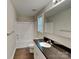 Clean bathroom with a combined shower and bath and granite countertops at 115 Dove Sw Ave, Concord, NC 28025