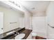Updated bathroom with granite countertop, white cabinets, and shower/tub combo at 115 Dove Sw Ave, Concord, NC 28025