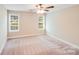 This bedroom boasts natural light with neutral walls and carpeted floors at 115 Dove Sw Ave, Concord, NC 28025