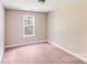 Cozy bedroom with a neutral color scheme and a bright window at 115 Dove Sw Ave, Concord, NC 28025