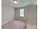 Carpeted bedroom with natural light, and neutral decor at 115 Dove Sw Ave, Concord, NC 28025